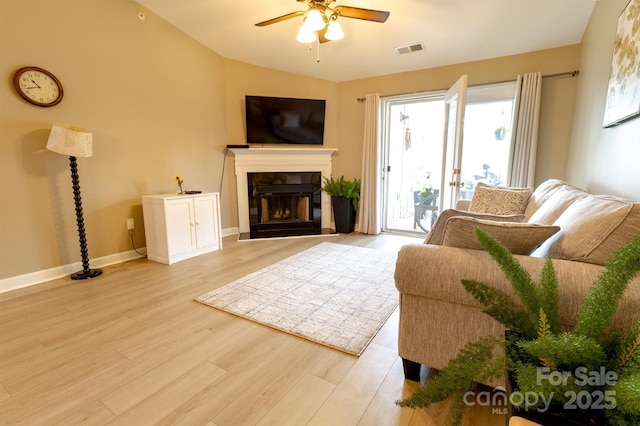 11867 Ridgeway Park Dr, Charlotte, NC 28277 - living room with a ceiling fan, light wood-style floors, a glass covered fireplace, and vaulted ceiling