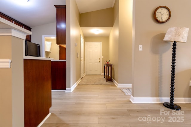 11867 Ridgeway Park Dr, Charlotte, NC 28277 - hallway with light wood-type flooring and vaulted ceiling