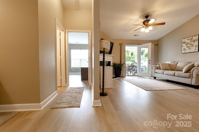 11867 Ridgeway Park Dr, Charlotte, NC 28277 - living area with a fireplace, ceiling fan, light wood finished floors, and lofted ceiling