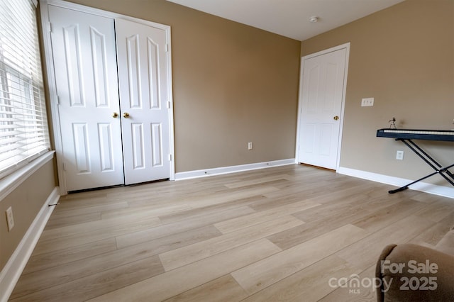11867 Ridgeway Park Dr, Charlotte, NC 28277 - unfurnished bedroom featuring light wood-style flooring and a closet