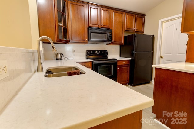 11867 Ridgeway Park Dr, Charlotte, NC 28277 - kitchen with black appliances, glass insert cabinets, light wood-style floors, and brown cabinetry