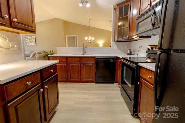 11867 Ridgeway Park Dr, Charlotte, NC 28277 - kitchen with black appliances, a peninsula, vaulted ceiling, a chandelier, and light countertops