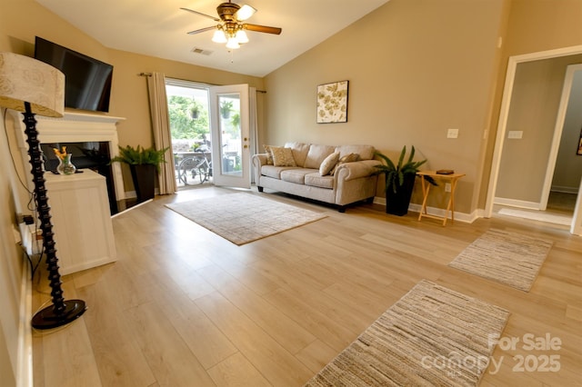 11867 Ridgeway Park Dr, Charlotte, NC 28277 - living area featuring ceiling fan, lofted ceiling, wood finished floors, and a glass covered fireplace
