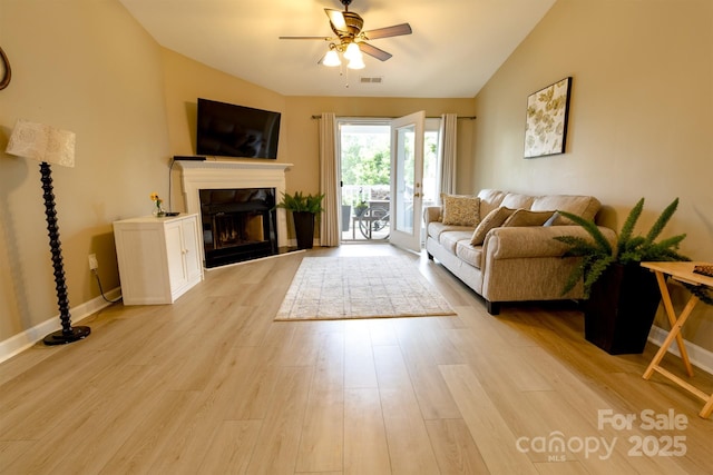 11867 Ridgeway Park Dr, Charlotte, NC 28277 - living area with ceiling fan, a glass covered fireplace, light wood finished floors, and lofted ceiling
