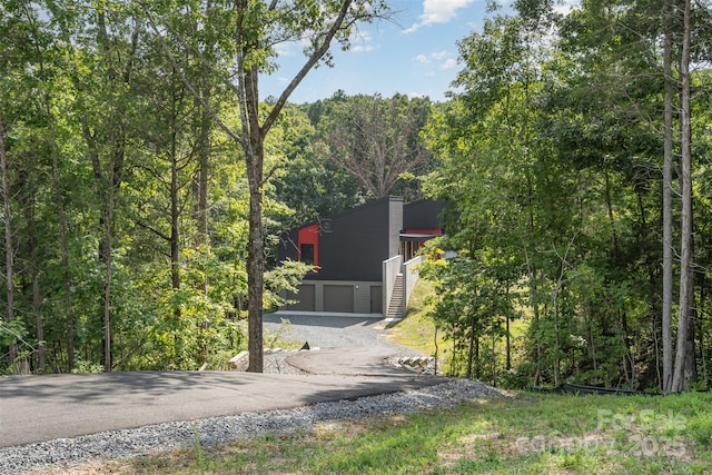 386 Squirrel Ln, Lake Wylie, SC 29710 - view of asphalt driveway featuring stairway and a wooded view