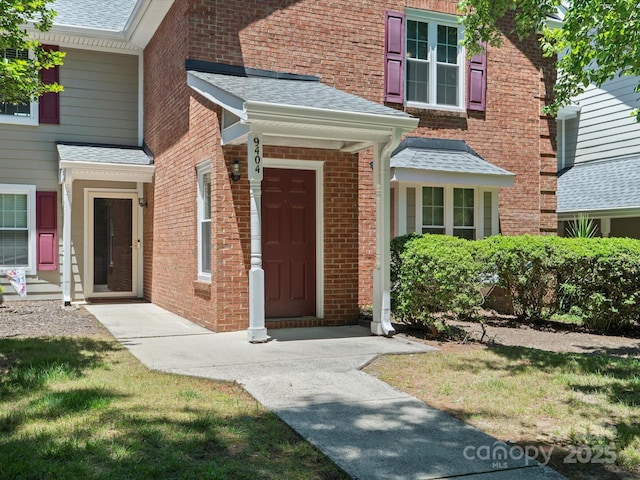 9404 S Vicksburg Park Ct, Charlotte, NC 28210 - view of exterior entry featuring brick siding and roof with shingles