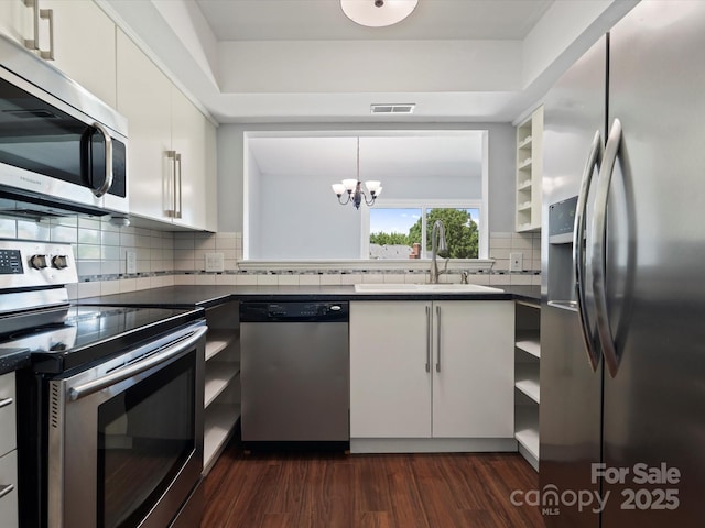 9404 S Vicksburg Park Ct, Charlotte, NC 28210 - kitchen featuring appliances with stainless steel finishes, a sink, dark countertops, open shelves, and white cabinets