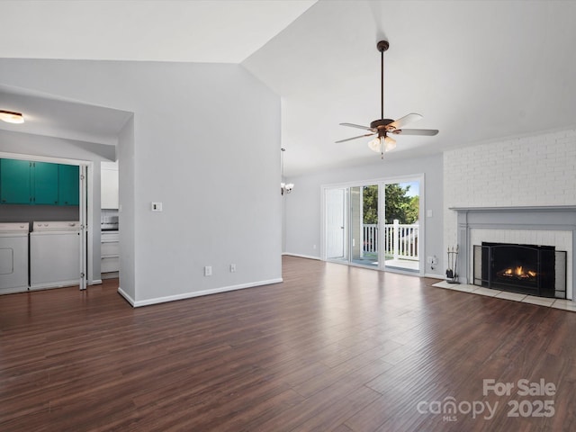 9404 S Vicksburg Park Ct, Charlotte, NC 28210 - unfurnished living room with washer and clothes dryer, ceiling fan, a brick fireplace, vaulted ceiling, and dark wood-style flooring
