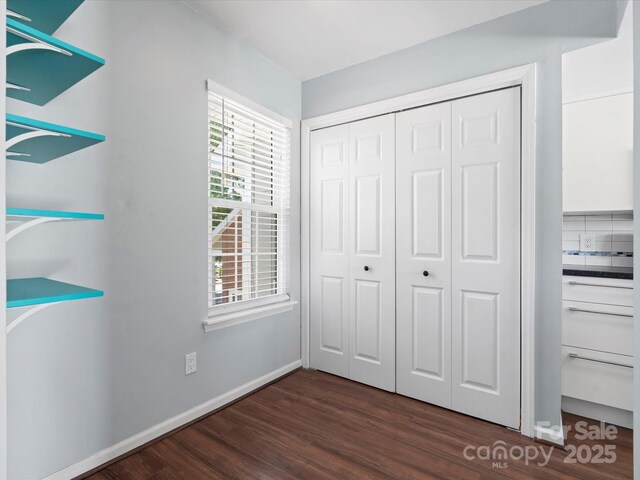 9404 S Vicksburg Park Ct, Charlotte, NC 28210 - unfurnished bedroom with dark wood finished floors, a closet, and baseboards