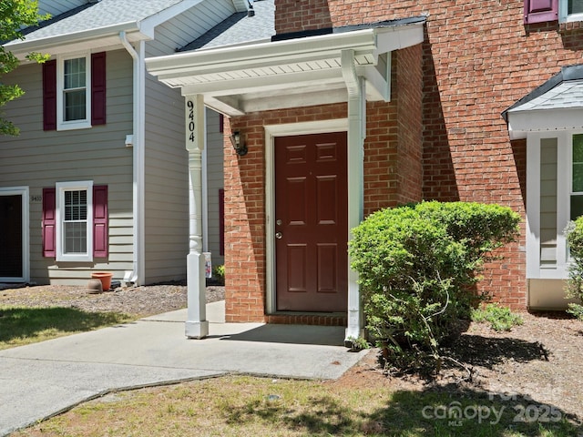 9404 S Vicksburg Park Ct, Charlotte, NC 28210 - property entrance with brick siding and roof with shingles
