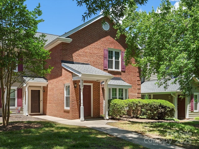 9404 S Vicksburg Park Ct, Charlotte, NC 28210 - traditional-style house featuring brick siding, roof with shingles, and a front yard