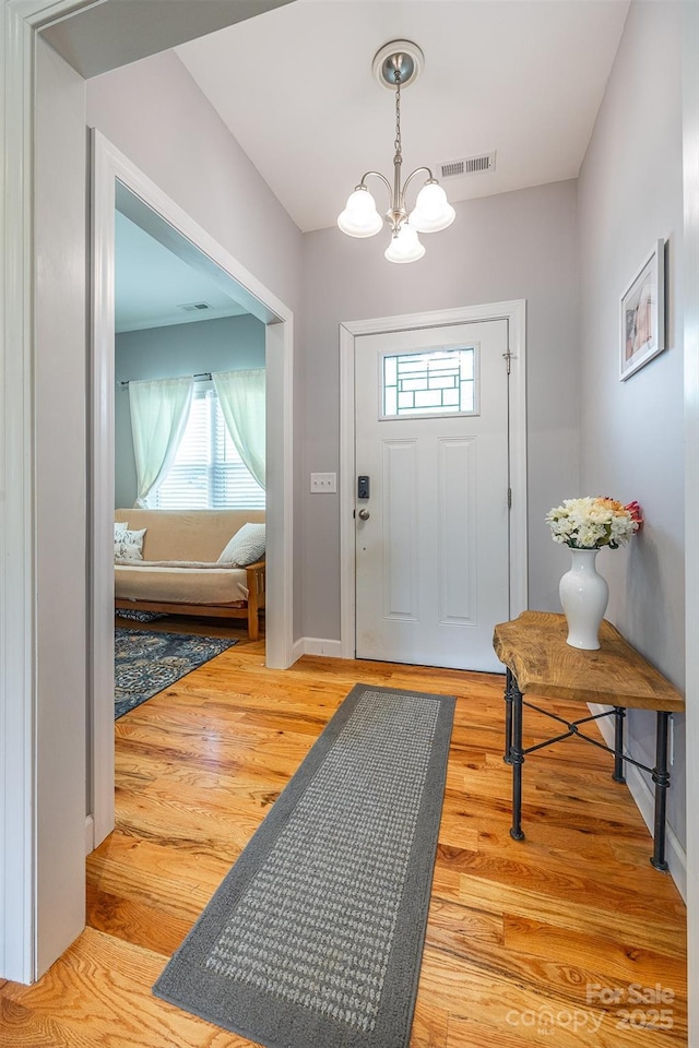 2146 Derby Ct, Morganton, NC 28655 - foyer with a chandelier, plenty of natural light, light wood-style flooring, and baseboards