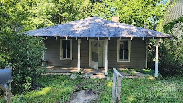 210 Mahan St SW, Concord, NC 28025 - view of front of property with a metal roof, a chimney, and covered porch