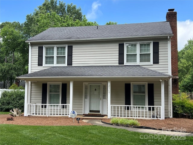 2507 Birnen Dr, Charlotte, NC 28210 - view of front of house with a porch, a chimney, roof with shingles, and a front yard