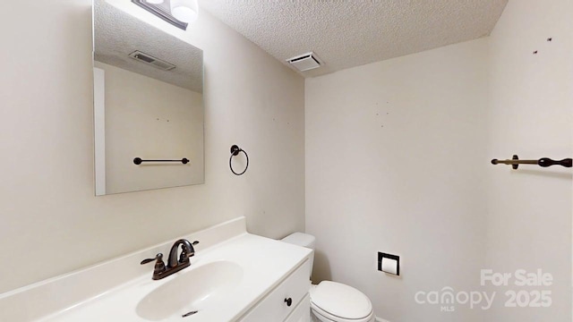 2507 Birnen Dr, Charlotte, NC 28210 - half bath with toilet, a textured ceiling, and vanity