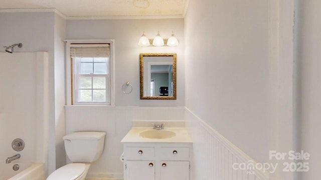 2507 Birnen Dr, Charlotte, NC 28210 - bathroom with a wainscoted wall, vanity, toilet, ornamental molding, and washtub / shower combination
