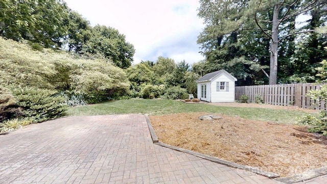 2507 Birnen Dr, Charlotte, NC 28210 - view of yard featuring an outdoor structure, a patio, and view of wooded area