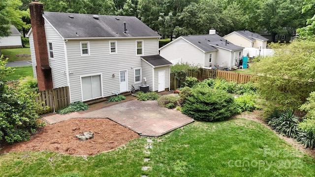 2507 Birnen Dr, Charlotte, NC 28210 - back of property featuring a chimney, roof with shingles, and a patio