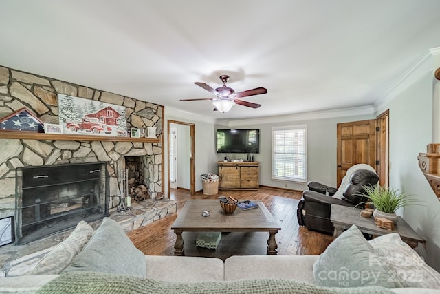 8698 Rocky River Rd, Harrisburg, NC 28075 - living area featuring ornamental molding, ceiling fan, a stone fireplace, and hardwood / wood-style floors