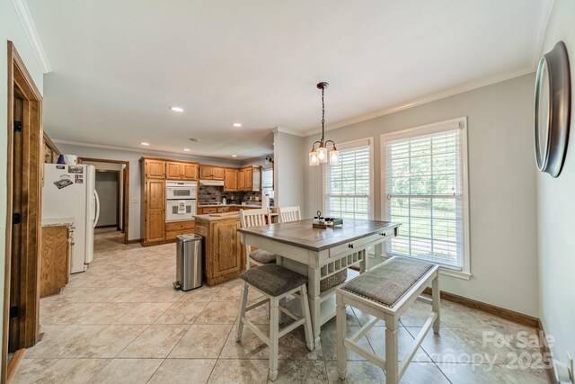 8698 Rocky River Rd, Harrisburg, NC 28075 - dining room with ornamental molding, healthy amount of natural light, a chandelier, recessed lighting, and baseboards