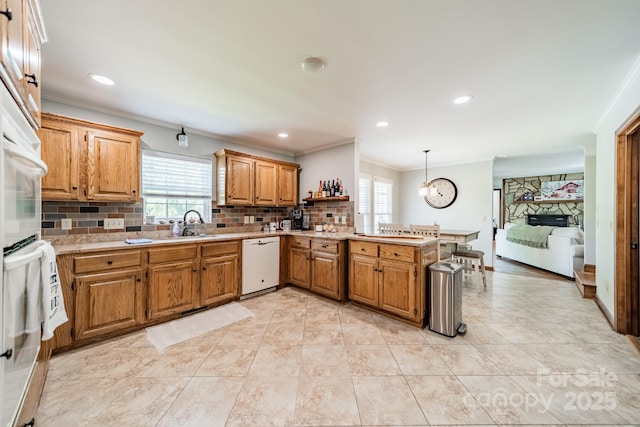 8698 Rocky River Rd, Harrisburg, NC 28075 - kitchen featuring dishwasher, a peninsula, plenty of natural light, tasteful backsplash, and crown molding