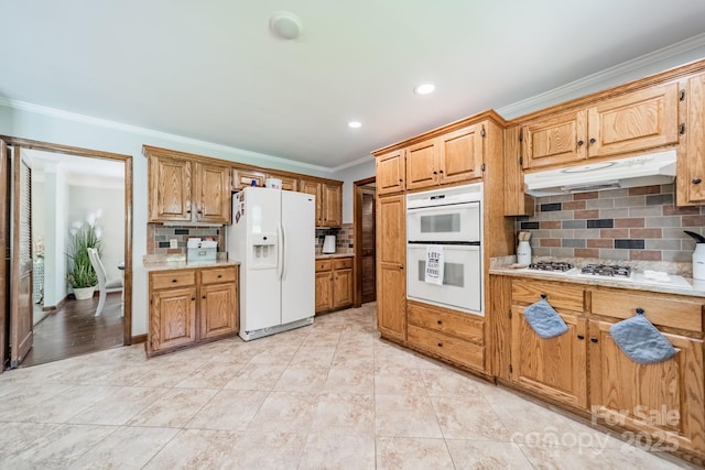 8698 Rocky River Rd, Harrisburg, NC 28075 - kitchen with white appliances, under cabinet range hood, decorative backsplash, light countertops, and ornamental molding