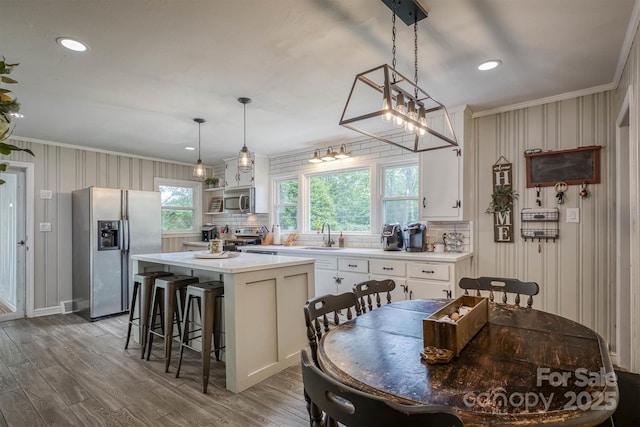 826 Jamestown Rd, Morganton, NC 28655 - kitchen with appliances with stainless steel finishes, crown molding, backsplash, light countertops, and white cabinets