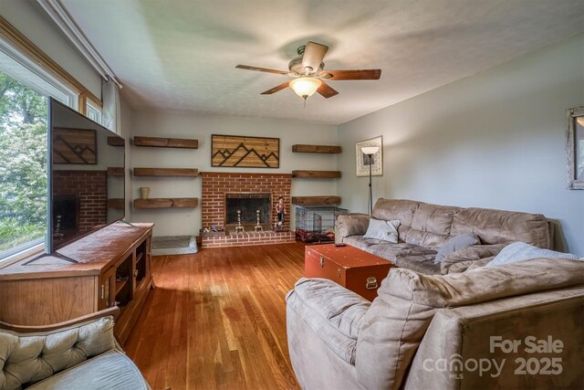 826 Jamestown Rd, Morganton, NC 28655 - living area featuring a brick fireplace, a ceiling fan, and wood finished floors