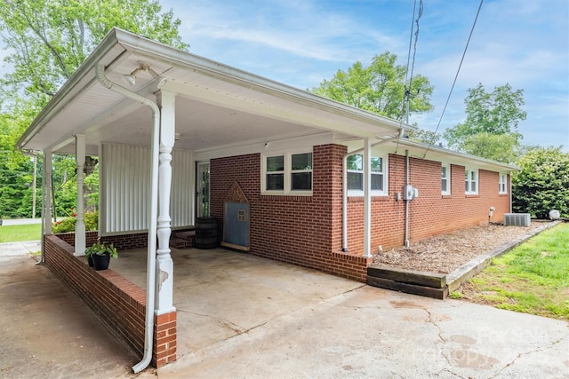 826 Jamestown Rd, Morganton, NC 28655 - view of property exterior featuring central AC unit, an attached carport, brick siding, and concrete driveway