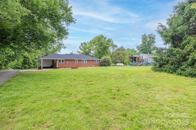 826 Jamestown Rd, Morganton, NC 28655 - view of green lawn with a playground, a carport, and asphalt driveway