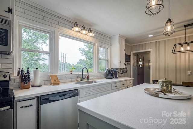826 Jamestown Rd, Morganton, NC 28655 - kitchen with appliances with stainless steel finishes, a sink, white cabinets, decorative backsplash, and ornamental molding