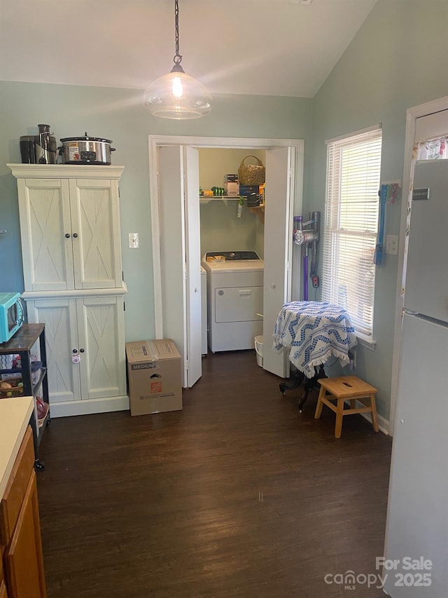 9612 Farmridge Ln, Matthews, NC 28105 - bedroom featuring washer / clothes dryer, freestanding refrigerator, dark wood-style floors, and vaulted ceiling