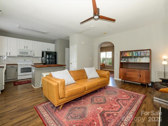 10639 Secret Garden Ln, Charlotte, NC 28214 - living area featuring arched walkways, dark wood finished floors, and a ceiling fan