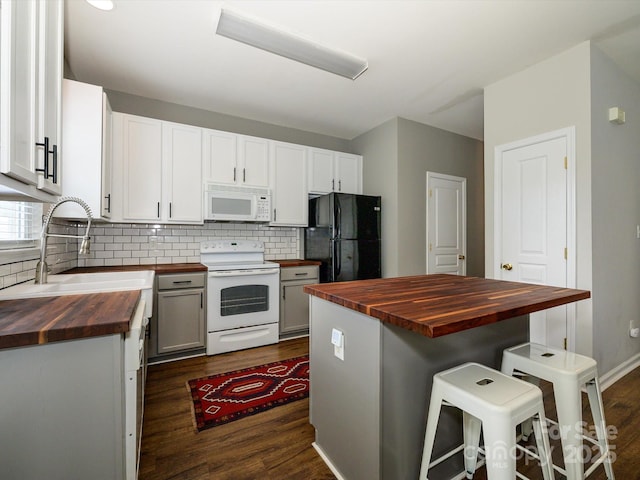10639 Secret Garden Ln, Charlotte, NC 28214 - kitchen with wooden counters, white appliances, a sink, dark wood finished floors, and backsplash