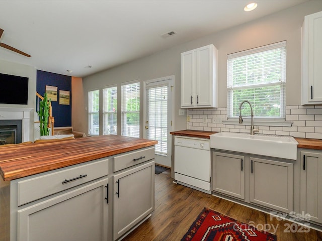 10639 Secret Garden Ln, Charlotte, NC 28214 - kitchen with wood counters, dishwasher, a sink, backsplash, and recessed lighting