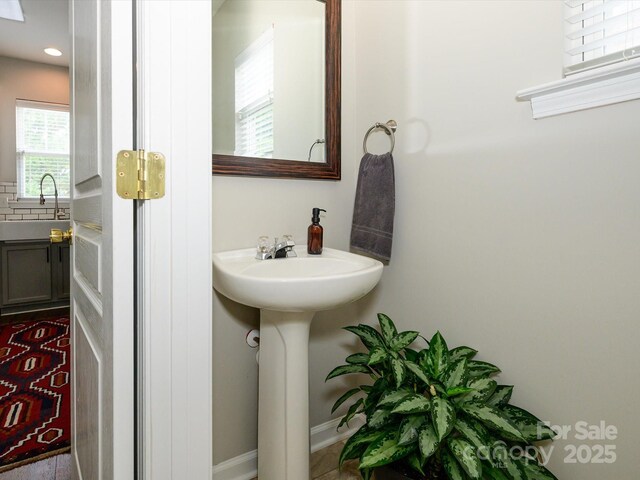 10639 Secret Garden Ln, Charlotte, NC 28214 - bathroom featuring a sink and baseboards