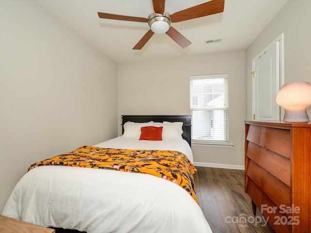 10639 Secret Garden Ln, Charlotte, NC 28214 - bedroom with dark wood-style flooring, baseboards, and a ceiling fan