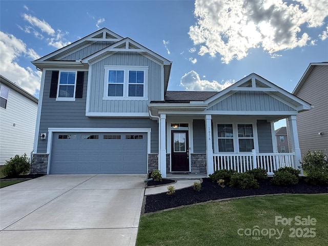 1016 Laggan Ln, Indian Trail, NC 28079 - craftsman house featuring board and batten siding, stone siding, a porch, a garage, and concrete driveway
