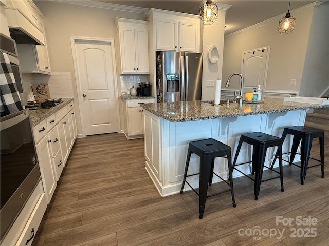 1016 Laggan Ln, Indian Trail, NC 28079 - kitchen featuring stainless steel fridge, crown molding, decorative backsplash, white cabinets, and a breakfast bar