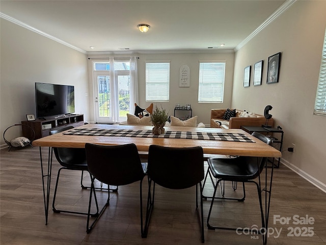 1016 Laggan Ln, Indian Trail, NC 28079 - dining room featuring plenty of natural light, dark wood-style flooring, ornamental molding, and baseboards