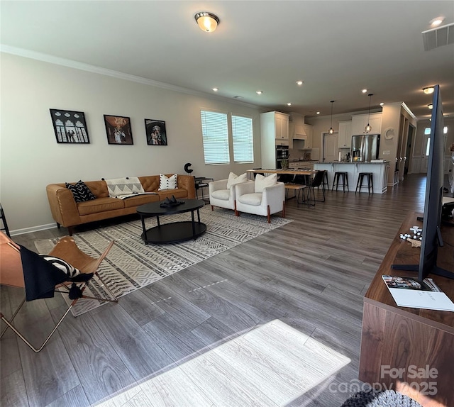 1016 Laggan Ln, Indian Trail, NC 28079 - living room with crown molding, wood finished floors, baseboards, and recessed lighting