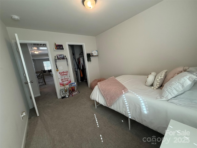 1016 Laggan Ln, Indian Trail, NC 28079 - carpeted bedroom featuring a spacious closet, a closet, and baseboards