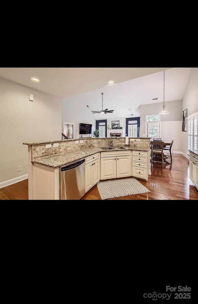 2234 Donnington Ln NW, Concord, NC 28027 - kitchen featuring stainless steel dishwasher, a sink, light wood-style floors, and baseboards