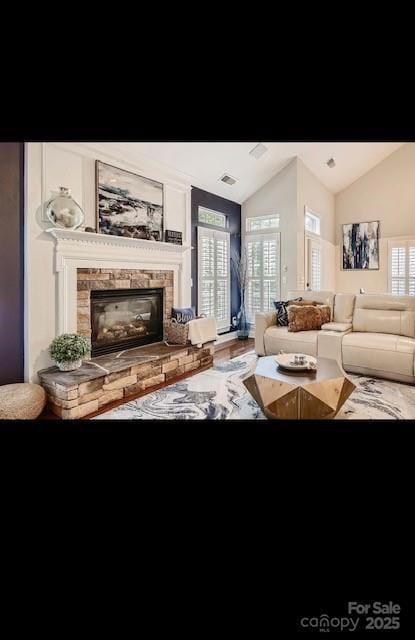 2234 Donnington Ln NW, Concord, NC 28027 - living area featuring vaulted ceiling and a glass covered fireplace