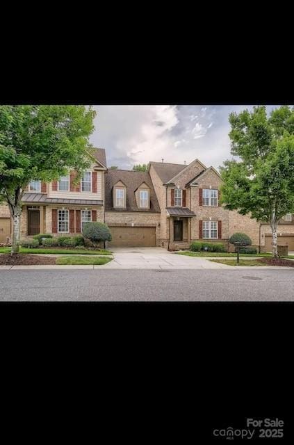 2234 Donnington Ln NW, Concord, NC 28027 - view of front of home featuring driveway, a standing seam roof, and a balcony