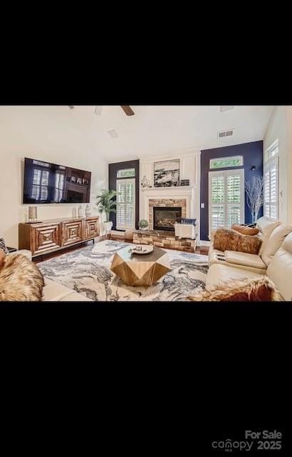 2234 Donnington Ln NW, Concord, NC 28027 - living area with lofted ceiling, a ceiling fan, and a fireplace
