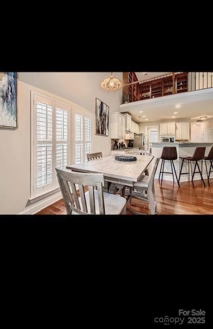 2234 Donnington Ln NW, Concord, NC 28027 - dining area with light wood-style flooring and a towering ceiling