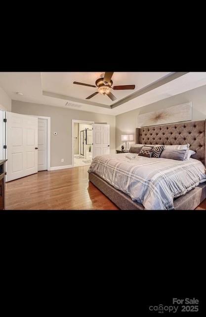 2234 Donnington Ln NW, Concord, NC 28027 - bedroom with a raised ceiling, wood finished floors, baseboards, and ceiling fan