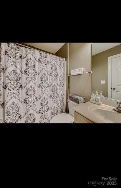 2234 Donnington Ln NW, Concord, NC 28027 - bathroom featuring vanity, toilet, and a shower with shower curtain