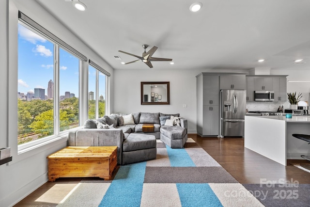 919 Cityscape Dr, Charlotte, NC 28205 - living room featuring a ceiling fan, recessed lighting, dark wood-style floors, baseboards, and a skyline view